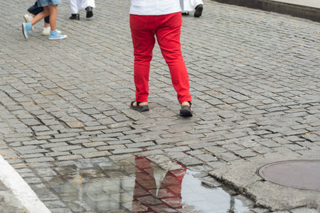 Half-body of people walking on the street wearing red clothes. Religious procession. Salvador, Brazilの写真素材