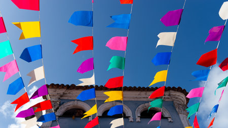Colorful plastic pennants for decoration against a blue sky. Decorative objects.