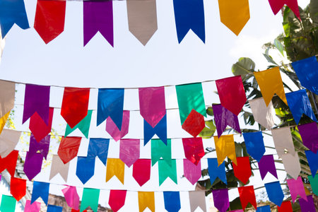 Colorful plastic pennants for decoration against a blue sky. Decorative objects.の写真素材