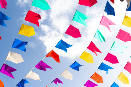 Colorful plastic pennants for decoration against a blue sky. Decorative objects.