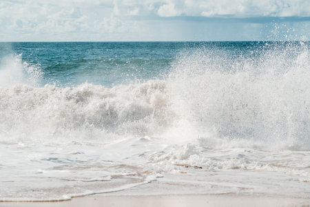 Ocean waves breaking on the shore of a beach. Hot summer day. Nature