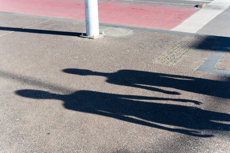 Shadow on the ground of two unidentified people. Human silhouette.