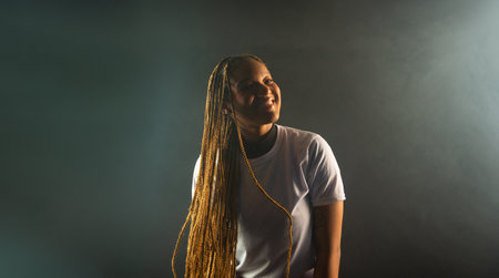 Salvador, Bahia, Brazil - August 30, 2025: Beautiful woman with braids posing for a studio photo...