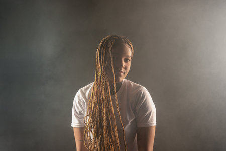 Salvador, Bahia, Brazil - August 30, 2025: Beautiful woman with braids posing for a studio photo...