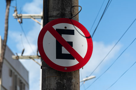 A close-up photo of a concrete pole, with a circular "No Parking" traffic sign.の写真素材