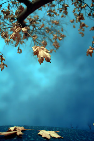 A vertical image with a color palette dominated by blue. Dried leaves, possibly from a sycamore tree, rest on a dark, grainy stone surface near the base of a tree trunk.の素材