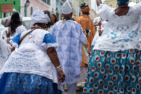 Salvador, Bahia, Brazil - November 25, 2025: A group of Bahian women in white lace clothing and colorful skirts are seen in a procession in Pelourinho, Salvador, Bahia.のeditorial素材