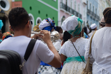 Salvador, Bahia, Brazil - November 25, 2025: A group of Bahian women in white lace clothing and colorful skirts are seen in a procession in Pelourinho, Salvador, Bahia.のeditorial素材