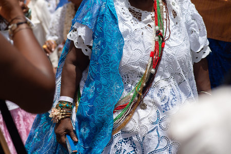 Salvador, Bahia, Brazil - November 25, 2025: Close-up of the torso and hands of a Baiana de AcarajÃ©, participating in the Baianas Day celebration in Pelourinho, Salvador, Bahia.のeditorial素材