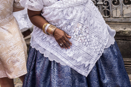 Salvador, Bahia, Brazil - November 25, 2025: Details of the body and clothing of the Baianas do Acaraje participating in their day in Pelourinho, Salvador, Bahia.のeditorial素材