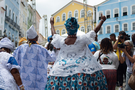 Salvador, Bahia, Brazil - November 25, 2025: A group of Bahian women in white lace clothing and colorful skirts are seen in a procession in Pelourinho, Salvador, Bahia.のeditorial素材