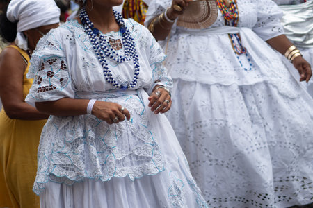 Salvador, Bahia, Brazil - November 25, 2025: Rear view of a group of Bahian women selling acaraje celebrating in the streets of Salvador, Bahia, in honor of their day.のeditorial素材