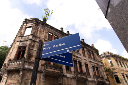 Salvador, Bahia, Brazil - August 13, 2025: Low-angle view of a blue street sign with the names Rua Pinto Martins. Salvador, Bahia.のeditorial素材