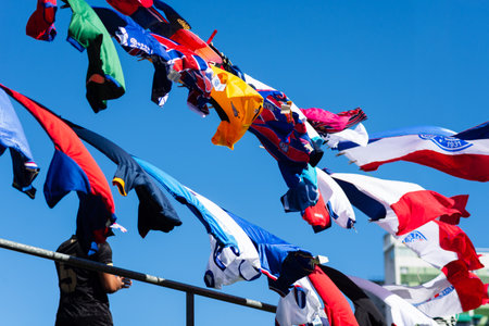 Salvador, Bahia, Brazil - November 2, 2025: Esporte Clube Bahia flags are seen hanging for sale on clotheslines around the Arena Fonte Nova before the Bahia vs. Bragantino game.のeditorial素材