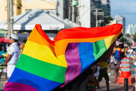 Salvador, Bahia, Brazil - September 14, 2025: View of people waving the rainbow-colored LGBT flag during a demonstration at Farol da Barra, Salvador, Bahia.のeditorial素材