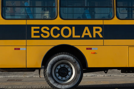 Salvador, Bahia, Brazil - December 12, 2025: Close-up of the side of a school bus with the word...