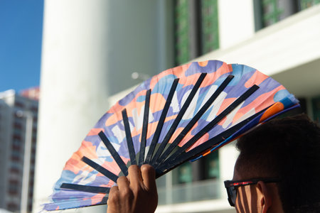 Salvador, Bahia, Brazil - September 14, 2025: Close-up of a hand holding an open fan with an LGBT print during an event in the city of Salvador, Bahia.のeditorial素材