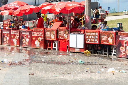 Salvador, Bahia, Brazil - February 7, 2026: Hundreds of styrofoam coolers and umbrellas bearing various beer brands are lined up for beverage sales during Carnival in Salvador, Bahia.のeditorial素材