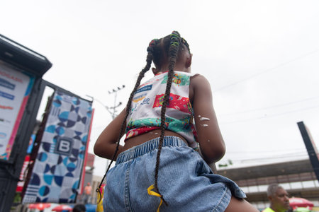 Salvador, Bahia, Brazil - February 14, 2026: Parents and children are seen having fun during a parade of floats at the Salvador Carnival in Bahia.のeditorial素材