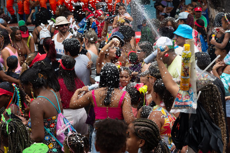 Salvador, Bahia, Brazil - February 14, 2026: Revelers are seen celebrating Carnival amidst a shower of foam and artificial snow in Salvador, Bahia.のeditorial素材
