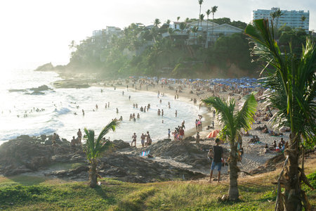 Salvador, Bahia, Brazil - January 11, 2026: Dozens of people are seen swimming in the sea at...