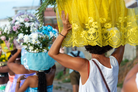 Salvador, Bahia, Brazil - February 3, 2026: People walk in procession carrying baskets of flowers...