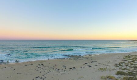 Sun Setting Over Ocean Coastline Beach