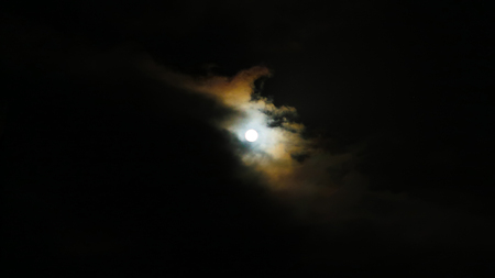 Moon behind the clouds on a winters night - South Africaの写真素材