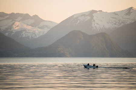 Sunset at a fjord with shipping boatの写真素材