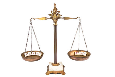 Balanced Scale between INCOME and TAXESの写真素材