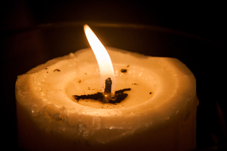 Candle light illuminates the dark surroundingの写真素材