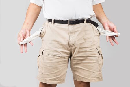 Men in shorts pulling his empty pocketsの写真素材
