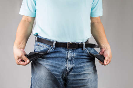 Men in jeans pulling his empty pocketsの写真素材