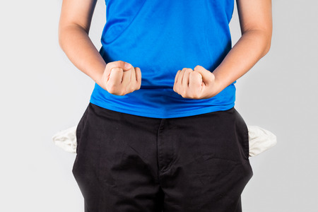 Teenager with empty pocket grip both fistの写真素材