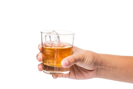 Hand holding a glass of whiskey on the rocksの写真素材