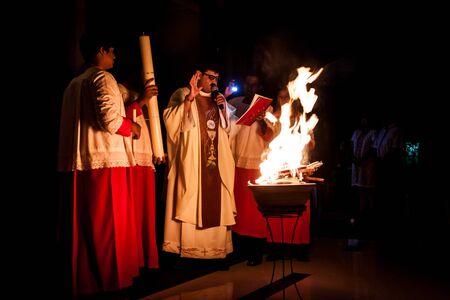 KUALA LUMPUR, April 19, 2014:  Catholics celebrated Easter eve mid-night mass at Church of St. Thomas More, Shah Alam in Malaysia.  Services were conducted in other Catholic churches as well.  The priest lighted up the new fire on the Paschal Candle as paのeditorial素材