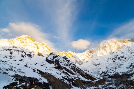 Sunrise rays on the peak of Annapurna South from Annapurna Base Camp, Nepalの写真素材