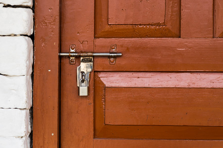 Basic latch and padlock are common way to secure guest rooms at Nepal tea housesの写真素材