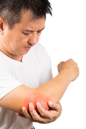 Matured man suffering from sore and painful elbowの写真素材