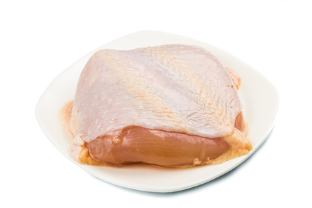 Fresh chicken breast meat with skin on plateの写真素材