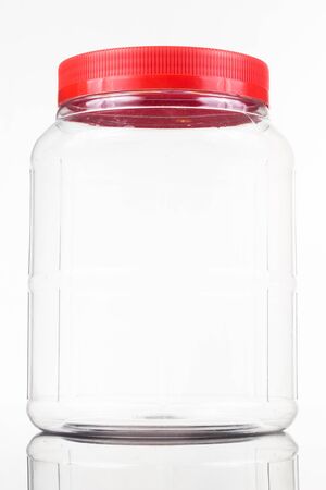 Translucent plastic PVC jar with red cover isolated in whiteの写真素材