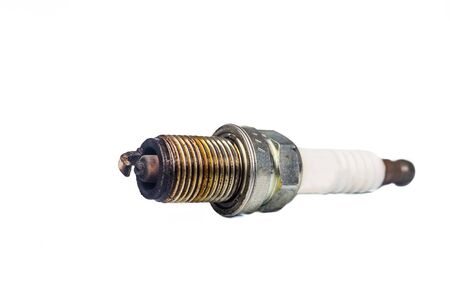 Close up of used spark plugs with focus on the electrode with deposits