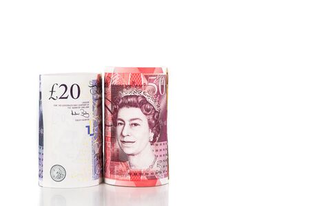 Close up of rolled up British Pound Sterling currency note.の写真素材