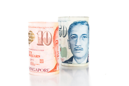Close up of rolled up Singapore Dollar currency note.