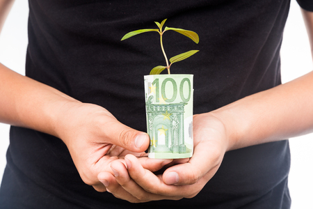 Concept of presenting plant growing from EURO money, symbolizing growing financial wealth.の写真素材