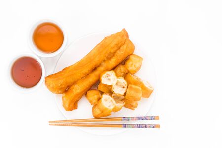 Fried bread stick or You Tiao served with Chinese teaの写真素材