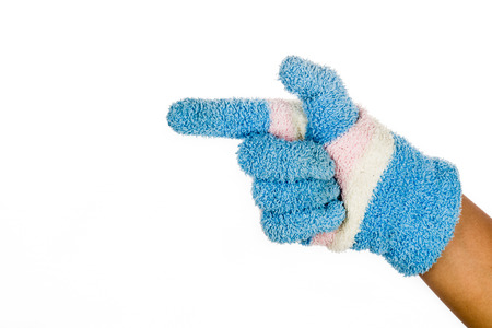 Hand in blue winter glove pointing direction against white backgroundの写真素材