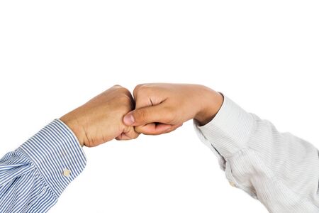 Fist bump on formal wear, gesturing an agreement and cooperationの写真素材