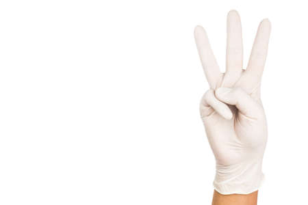 Hand in surgical latex glove gesture number Three.の写真素材