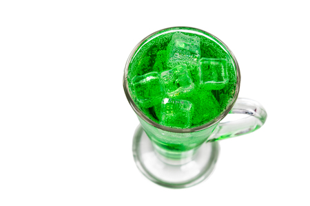 Refreshing green fizzy soft drink with ice in transperant glass.の写真素材